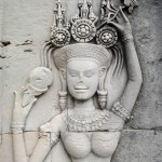 The carving of an apsara, in Angkor Wat, eating ice cream. I think.