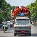 Monks atop a pick-up bus, the chronically overloaded local public transport.