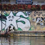 Lone man in front of a graffiti